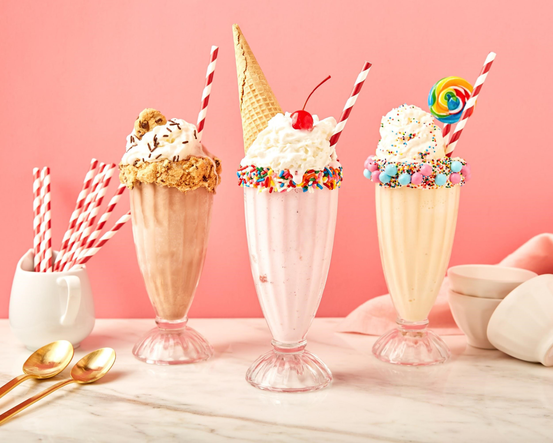 Three hand-spun milkshakes topped with whipped cream, cookies, and sprinkles